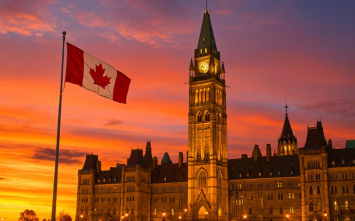 Parliament Hill and the Canadian flag at sunset